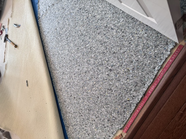 During carpet stretching with pad exposed